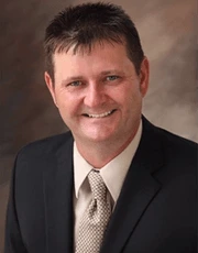 Portrait of Scott Sanders in a dark suit and tie